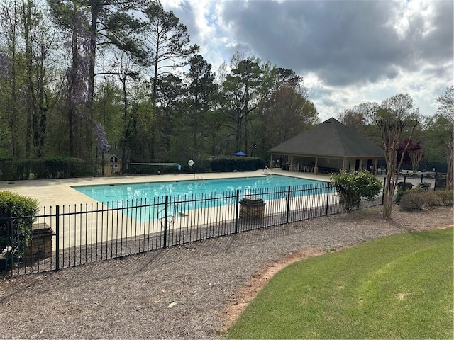 pool featuring fence, a yard, and a patio area