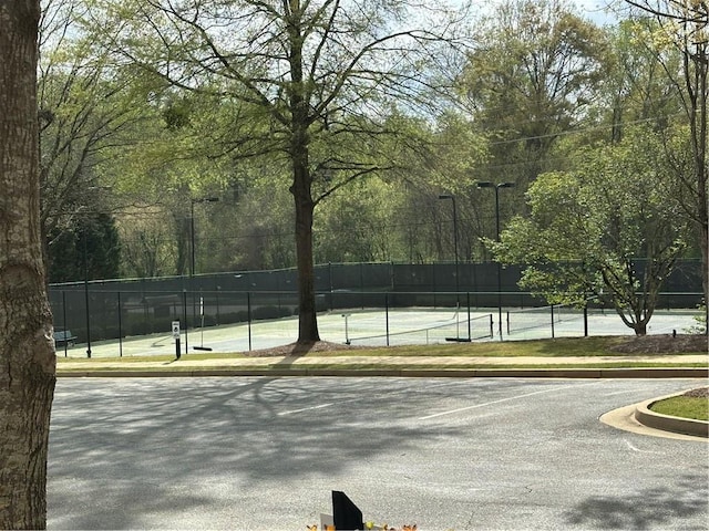 view of sport court featuring fence