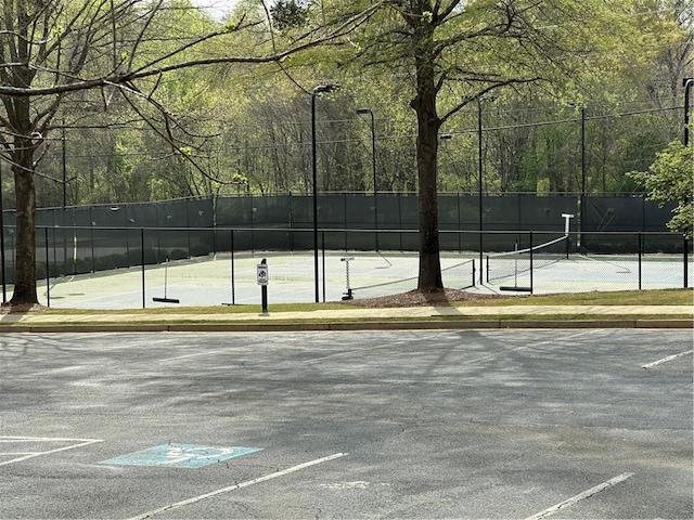 view of sport court featuring fence