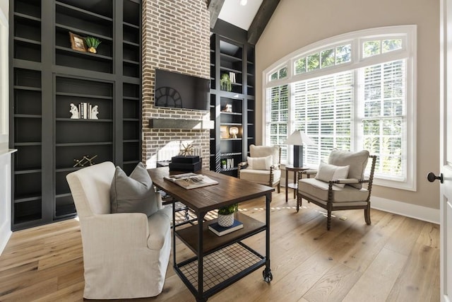 living area with a fireplace, wood-type flooring, and lofted ceiling