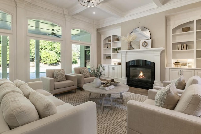 living room with ceiling fan, beamed ceiling, ornamental molding, coffered ceiling, and hardwood / wood-style flooring