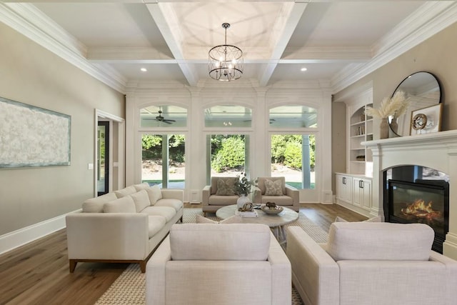 living room with hardwood / wood-style flooring, ceiling fan with notable chandelier, crown molding, coffered ceiling, and beam ceiling