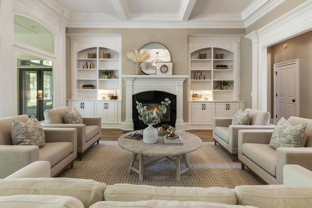 living room with built in shelves, hardwood / wood-style flooring, crown molding, and beam ceiling