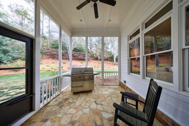 sunroom / solarium featuring a wealth of natural light and ceiling fan