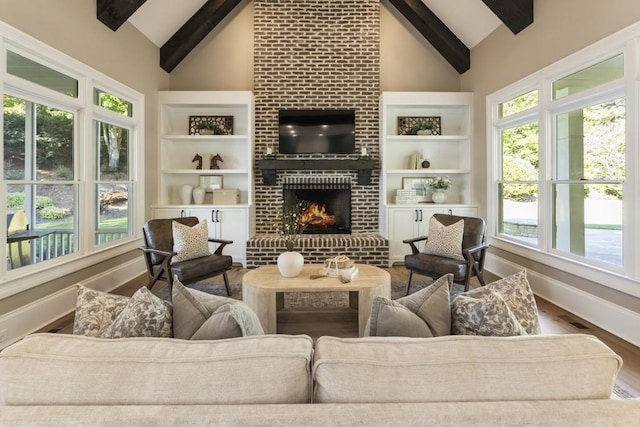 living room with hardwood / wood-style flooring, a fireplace, high vaulted ceiling, and beamed ceiling