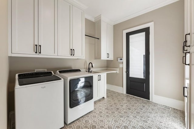 laundry area with ornamental molding, washer and dryer, sink, and cabinets