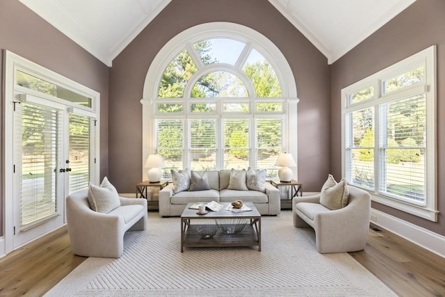 sunroom with plenty of natural light and vaulted ceiling