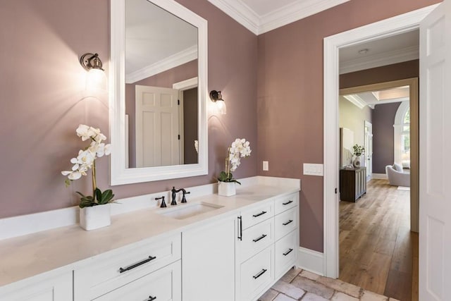 bathroom featuring wood-type flooring, vanity, and ornamental molding