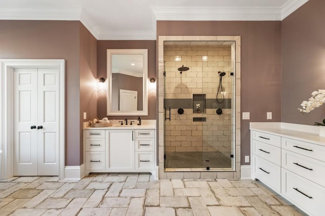 bathroom featuring vanity, a shower with shower door, and crown molding