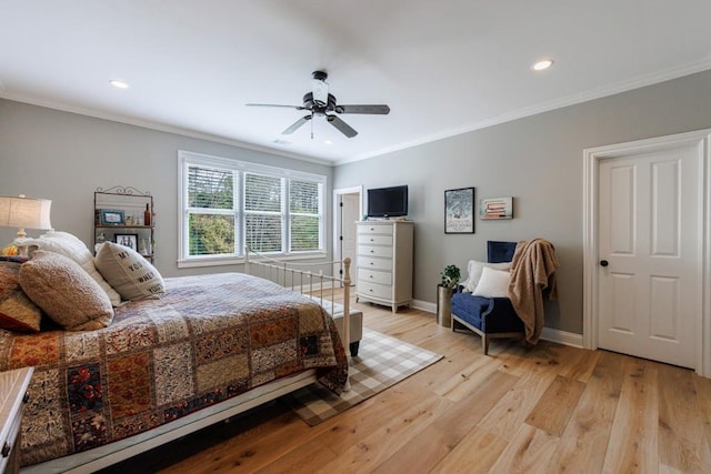 bedroom with ceiling fan, ornamental molding, and light hardwood / wood-style floors