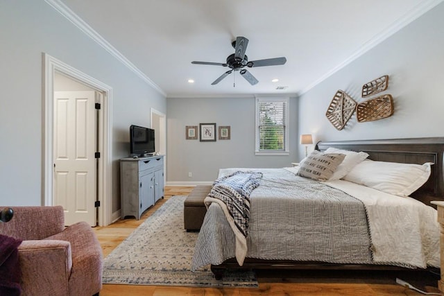 bedroom with ornamental molding, light wood-type flooring, and ceiling fan