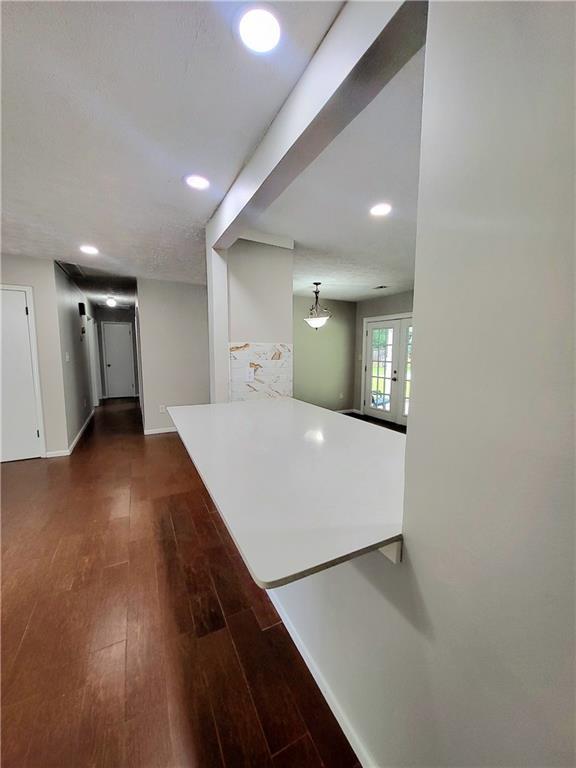 2913 Jordan Forest Trl, Lawrenceville, GA 30044 - kitchen featuring dark wood-style floors, recessed lighting, french doors, and a peninsula