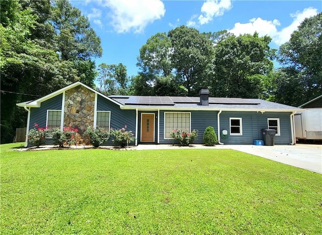 2913 Jordan Forest Trl, Lawrenceville, GA 30044 - view of front facade featuring solar panels, a front lawn, and a chimney
