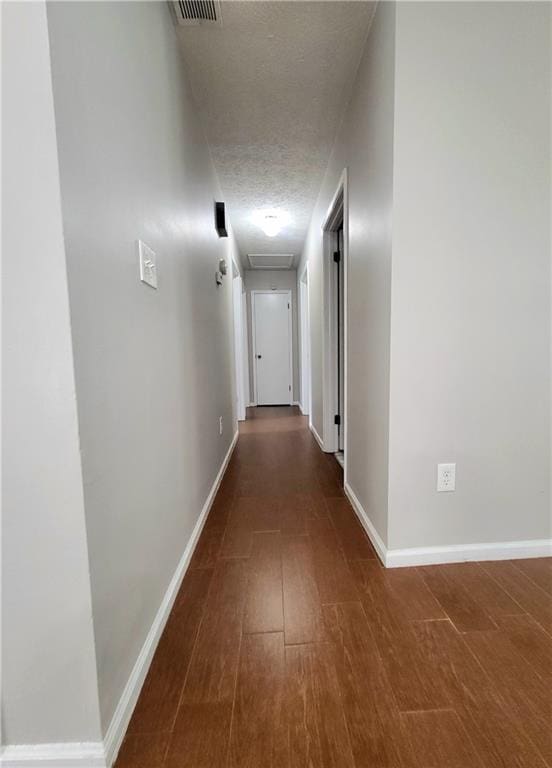 2913 Jordan Forest Trl, Lawrenceville, GA 30044 - hall with wood finished floors, a textured ceiling, and attic access