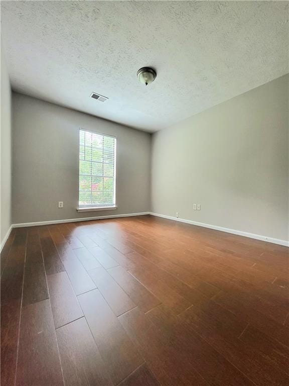 2913 Jordan Forest Trl, Lawrenceville, GA 30044 - unfurnished room with dark wood finished floors and a textured ceiling