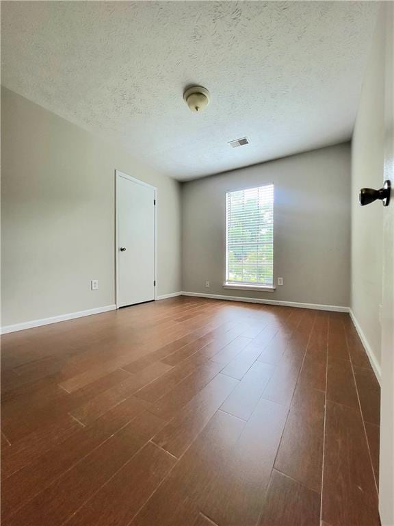 2913 Jordan Forest Trl, Lawrenceville, GA 30044 - unfurnished room featuring dark wood-type flooring and a textured ceiling
