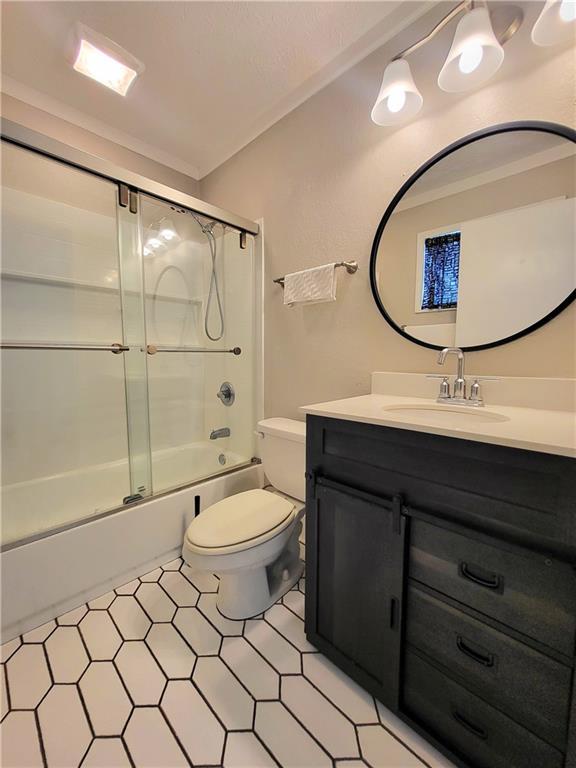 2913 Jordan Forest Trl, Lawrenceville, GA 30044 - full bathroom featuring vanity and shower / bath combination with glass door