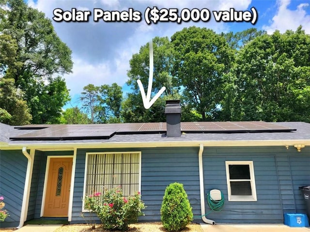 2913 Jordan Forest Trl, Lawrenceville, GA 30044 - view of front of property featuring solar panels, a chimney, and a shingled roof