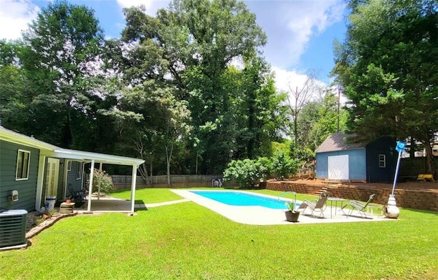 2913 Jordan Forest Trl, Lawrenceville, GA 30044 - view of swimming pool with a patio, a fenced backyard, a storage unit, and view of scattered trees