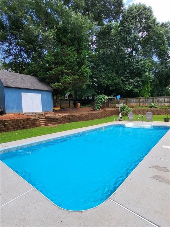 2913 Jordan Forest Trl, Lawrenceville, GA 30044 - view of swimming pool with a shed, view of scattered trees, and a patio area