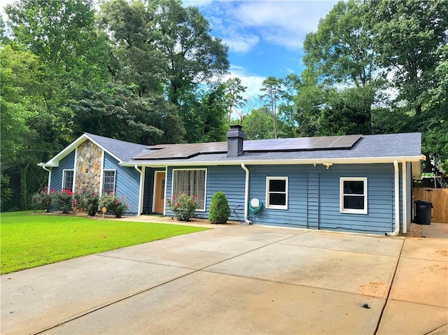 2913 Jordan Forest Trl, Lawrenceville, GA 30044 - ranch-style home with solar panels, a chimney, and driveway