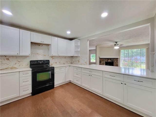 2913 Jordan Forest Trl, Lawrenceville, GA 30044 - kitchen featuring black electric range oven, open shelves, tasteful backsplash, light wood finished floors, and a ceiling fan