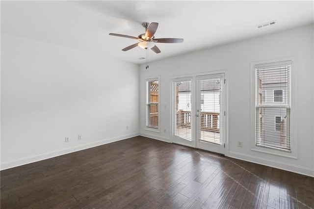 spare room with dark wood-type flooring, ceiling fan, and french doors