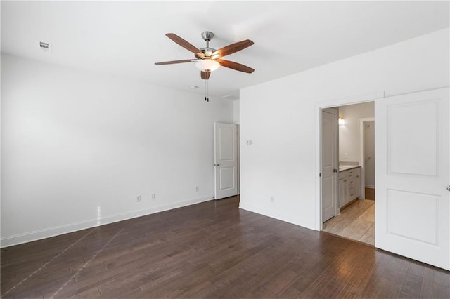 unfurnished bedroom with hardwood / wood-style floors, ceiling fan, and ensuite bath