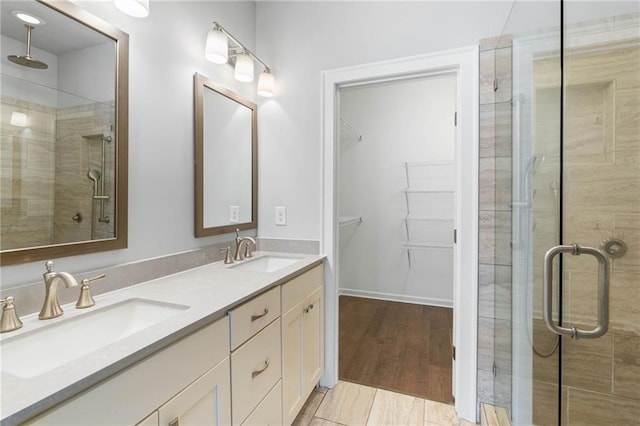 bathroom with vanity and a shower with door