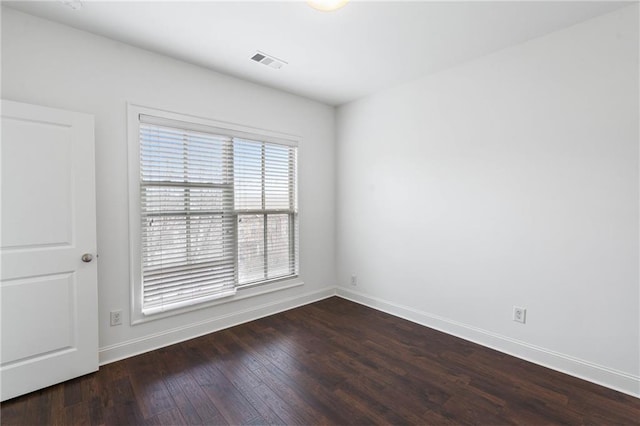 empty room featuring wood-type flooring and plenty of natural light