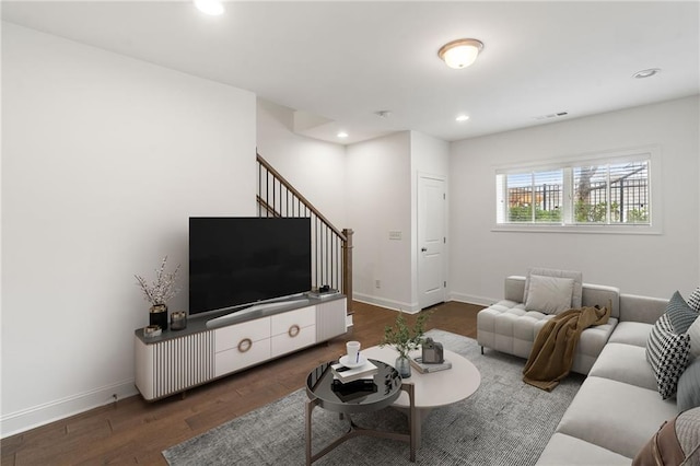 living room with dark hardwood / wood-style flooring