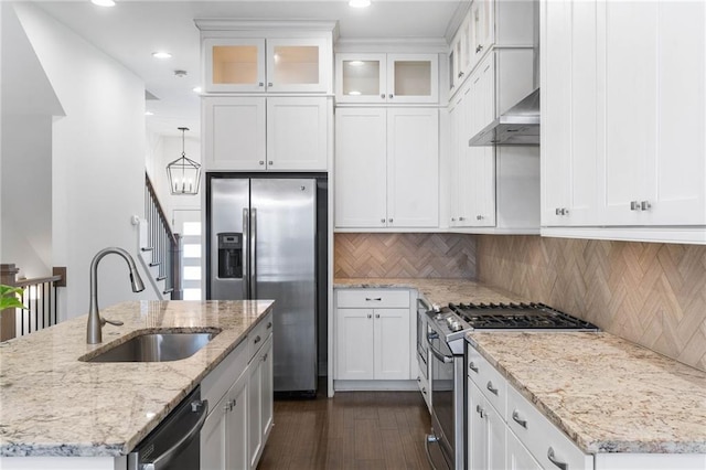 kitchen featuring white cabinetry, appliances with stainless steel finishes, sink, and wall chimney range hood