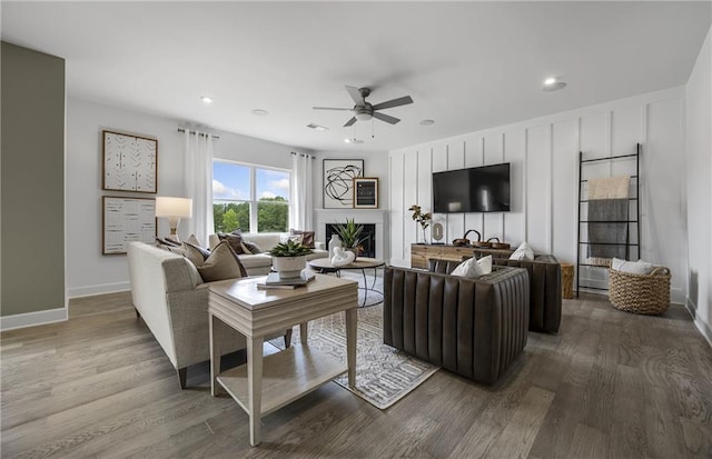 317 Foxglove Way, Mcdonough, GA 30253 - living room with a ceiling fan, wood finished floors, a lit fireplace, baseboards, and recessed lighting
