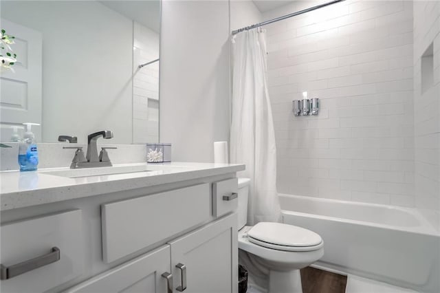 full bathroom featuring shower / bath combo with shower curtain, vanity, wood-type flooring, and toilet