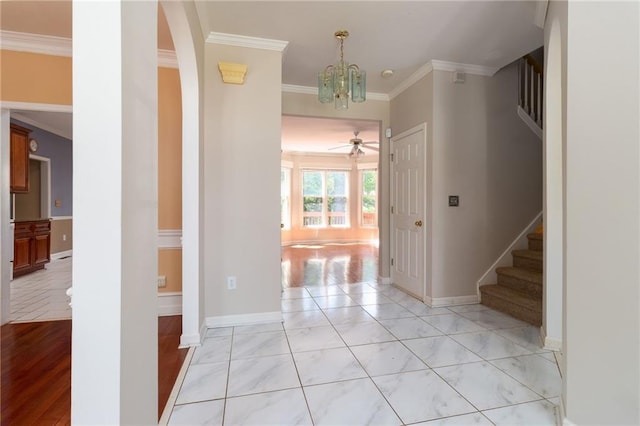 5287 Wild Indigo Way, Acworth, GA 30102 - foyer featuring crown molding, stairs, a ceiling fan, a chandelier, and arched walkways