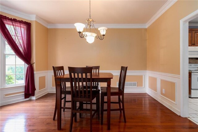 5287 Wild Indigo Way, Acworth, GA 30102 - dining room with a chandelier, dark wood finished floors, ornamental molding, and wainscoting