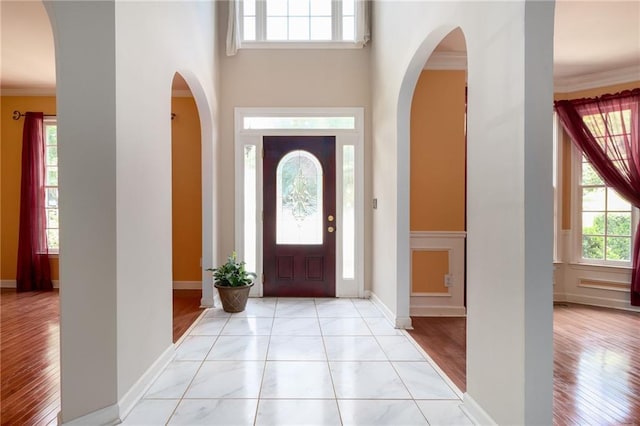 5287 Wild Indigo Way, Acworth, GA 30102 - foyer with light wood finished floors, ornamental molding, arched walkways, and a towering ceiling