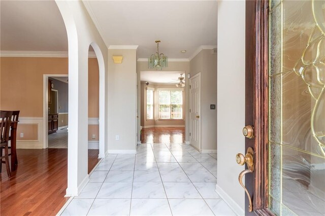 5287 Wild Indigo Way, Acworth, GA 30102 - entrance foyer featuring arched walkways, ornamental molding, a chandelier, and ceiling fan