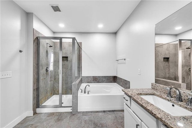 full bath with visible vents, baseboards, a garden tub, vanity, and a shower stall