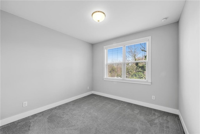 unfurnished room with carpet and baseboards