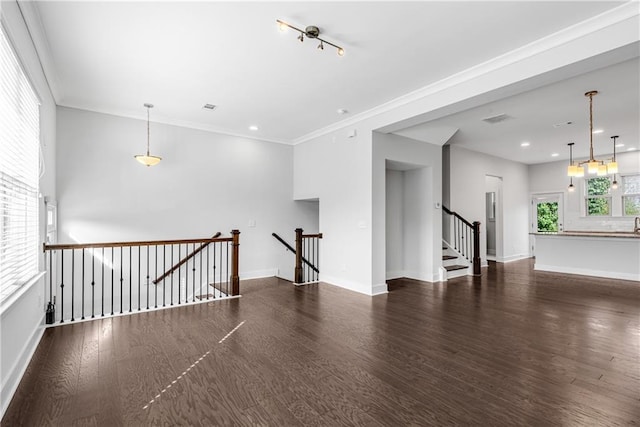 spare room with ornamental molding, dark wood-type flooring, visible vents, and baseboards