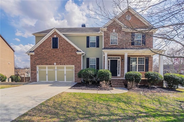 traditional-style house with a front yard, brick siding, concrete driveway, and an attached garage