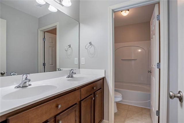 full bath with double vanity, toilet, shower / bathing tub combination, and a sink