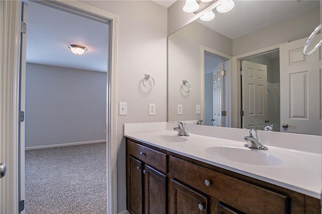 full bathroom with double vanity, baseboards, and a sink