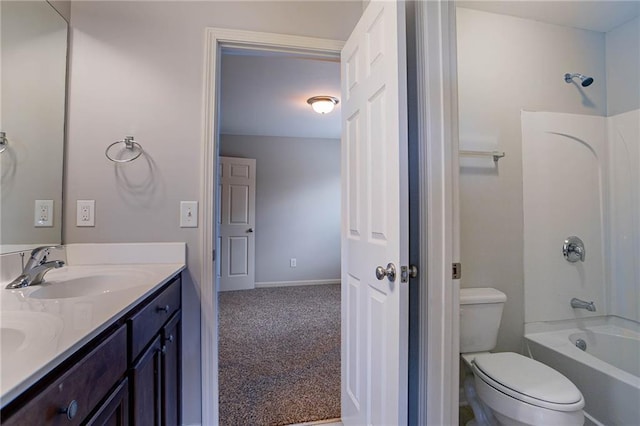 bathroom featuring baseboards, double vanity, a sink, bathtub / shower combination, and toilet