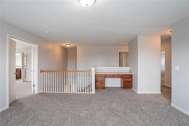 carpeted empty room featuring baseboards