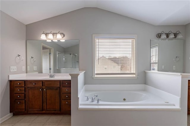 bathroom with a stall shower, a whirlpool tub, tile patterned flooring, vanity, and vaulted ceiling