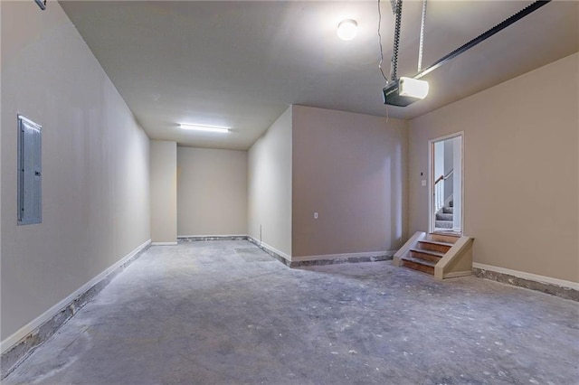 garage featuring a garage door opener and baseboards