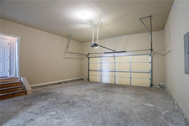 garage with a garage door opener and baseboards