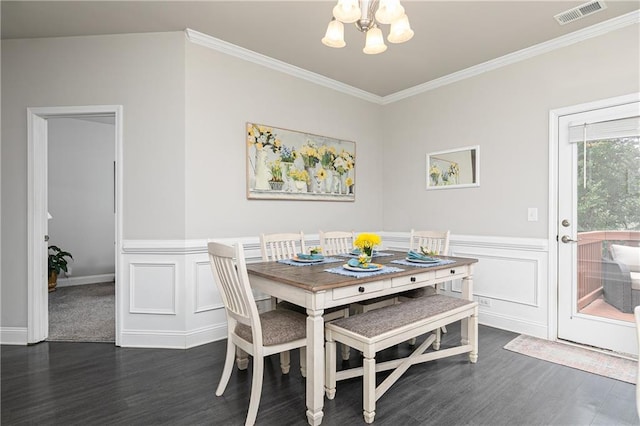 3302 Bellingham Way, Lithia Springs, GA 30122 - dining space featuring a chandelier, crown molding, dark wood-style floors, and wainscoting
